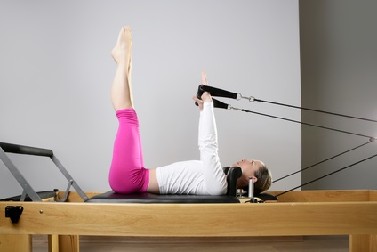 gym woman pilates stretching sport in reformer bed